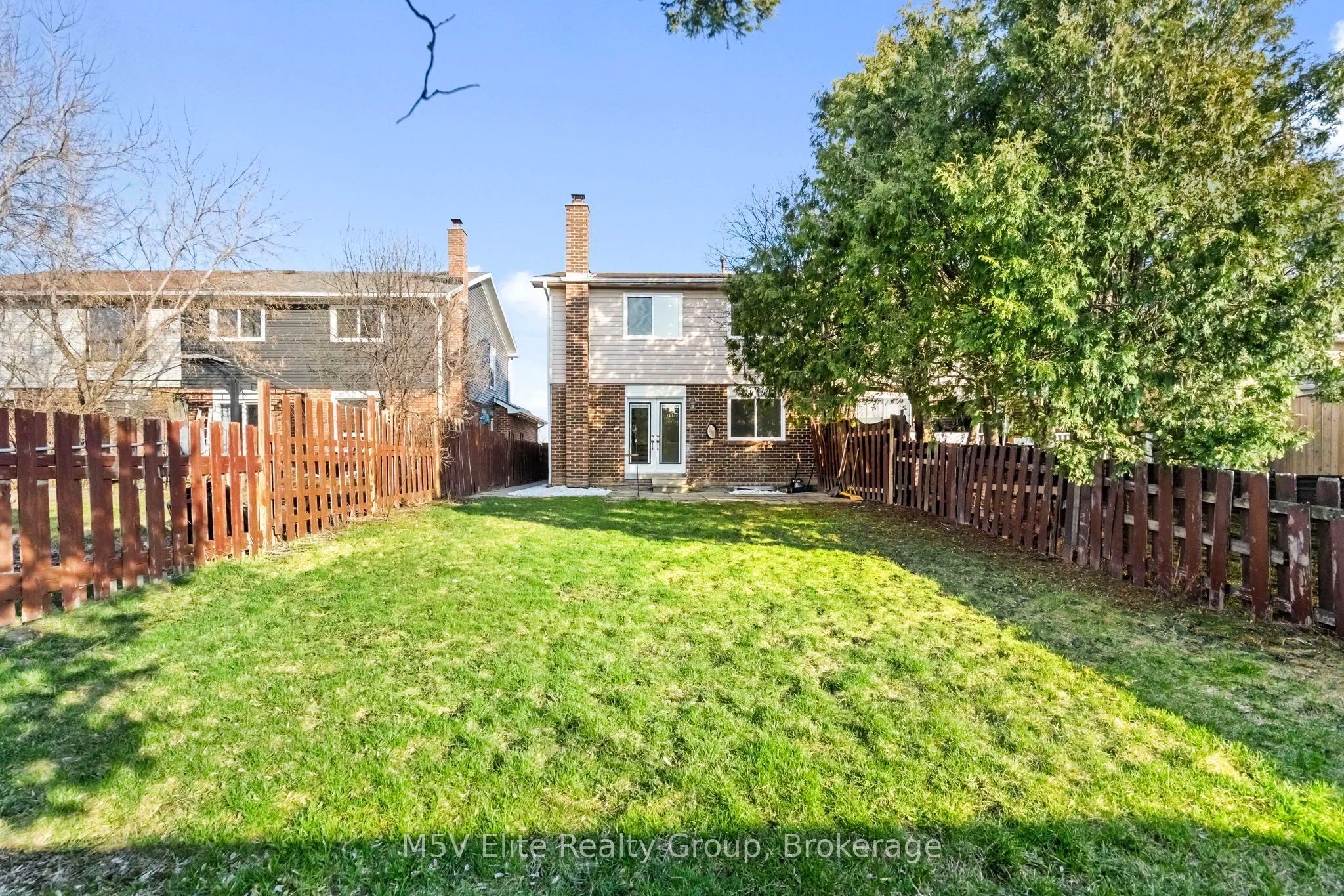 Private fenced backyard with mature trees